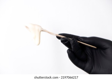 Sugar Depilation. A Piece Of Sugar Paste Dripping From A Wooden Spatula