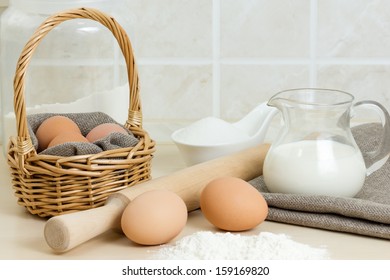 Sugar, Flour, Milk, Rolling Pin And Basket With Eggs