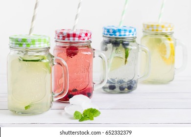 Sugar Free And Gluten Free Homemade Drinks With Trendy Mason Jars And Colorful Straws Placed On White Wooden Board.