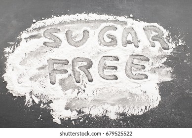 Sugar free written on in sugar on black background.