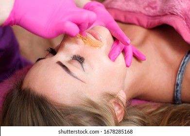 Sugar hair removal from woman body. Wax epilation spa procedure. Procedure beautician female. Mustache.