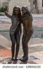 Sugar Land, Texas, United States Of America - January 16, 2017. Statue Of Two Girls Posing For A Selfie Photo On Town Square In Sugar Land, TX.