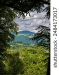 Sugar Loaf mountain in the Brecon Beacons viewed from the Beech forest at the Clydach Gorge