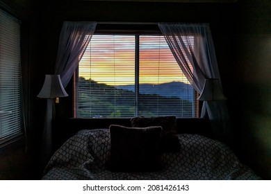 Sugar Mountain, North Carolina View Through Window Of Blue Ridge Mountains At Sunset From Bedroom Room Of House Home Or Apartment With Curtains And Bed