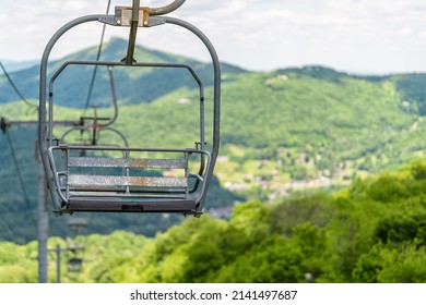 Sugar Mountain Ski Resort Town In Summer With Closeup Of Ski Chair Lift Slope And Green Lush Foliage Bokeh Background In North Carolina Blue Ridge Appalachia