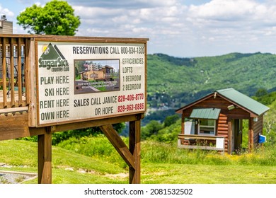 Sugar Mountain, USA - June 16, 2021: Ski Resort Country Club Sign Rentals And Reservations Phone In Banner Elk Town In Summer In North Carolina With Apartment Buildings In Blue Ridge Appalachia