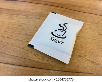 Sugar Packet On The Wooden Table