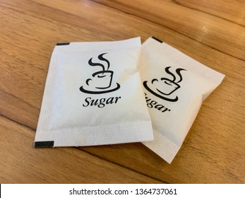 Sugar Packet On The Wooden Table