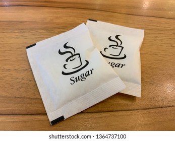 Sugar Packet On The Wooden Table