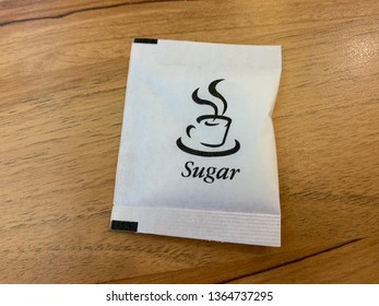 Sugar Packet On The Wooden Table