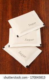 Sugar Packet On The Wooden Table          