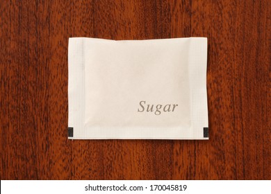 Sugar Packet On The Wooden Table          