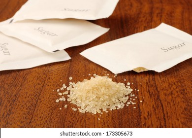 Sugar Packet On The Wooden Table    