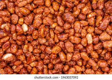Sugar peanuts background and texture on the street market. Glazed and roasted peanuts. High quality photo