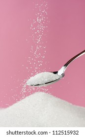 Sugar Pouring From A Spoon To A Pile