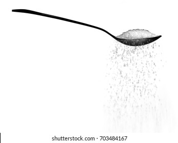 Sugar Or Salt Falling From A Spoon Isolated On White