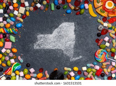 Sugar in the shape of New York surrounded by a variety of sweets. (series)