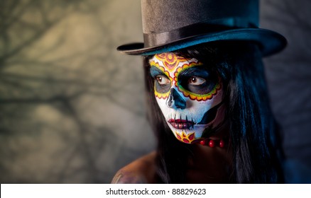 Sugar skull girl in tophat, in the forest