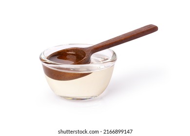 Sugar syrup in glass bowl isolated on white background with clipping path.