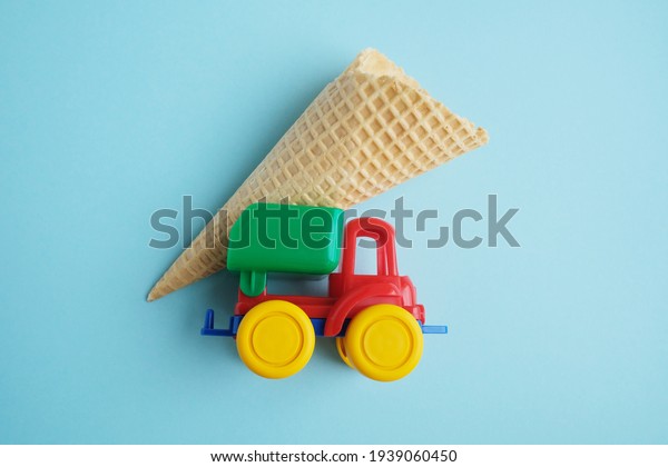 Sugar\
waffle tube delivered by car on a blue\
background.