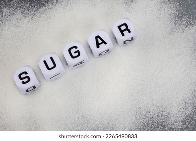 Sugar written in letter dice on white sugar granules - Powered by Shutterstock