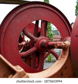 Sugarcane Mill Pulley Axle Painted Red, Close-up Shot Of The Outdoors.