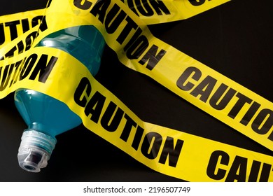 Sugary Sports Drink Plastic Bottle Wrapped In Yellow Caution Tape With Copy Space Concept For Dangerous Liquid Candy, Warning About Beverages With High Sugar Content And Guidance Against Obesity