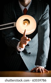 Suggestive Interrogation Concept - Interrogating Person Standing Behind Desk Lamp