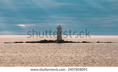 The suggestive Mangiabarche lighthouse photographed from the cliff of the island of Sant'Antioco near Calasetta
