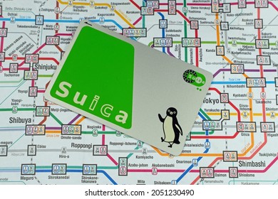 Suica IC Metro prepaid travel card on a train map of Tokyo. London - 2nd October 2021