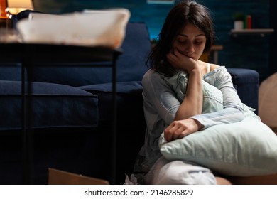 Suicidal Depressed Person In Pain And Solitude At Home, Dealing With Chronic Disease Difficulties And Depression On Living Room Floor. Desperate Anxious Woman With Mental Health Negativity.