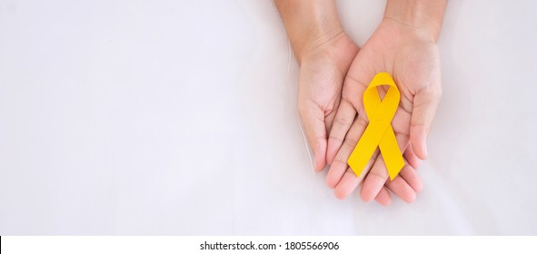 Suicide Prevention And Childhood Cancer Awareness, Yellow Ribbon For Supporting People Living And Illness. Children Healthcare And World Cancer Day Concept