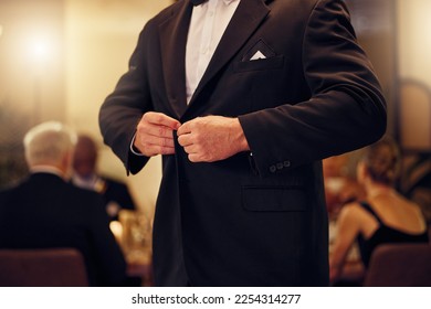 Suit, formal and man tie the button of his jacket at a fancy dinner, party or event banquet. Classy, elegance and male fixing blazer of his elegant outfit at classic supper, celebration or gathering.