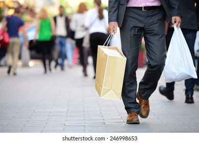 Suit with shopping bags on shopping street - Shutterstock ID 246998653