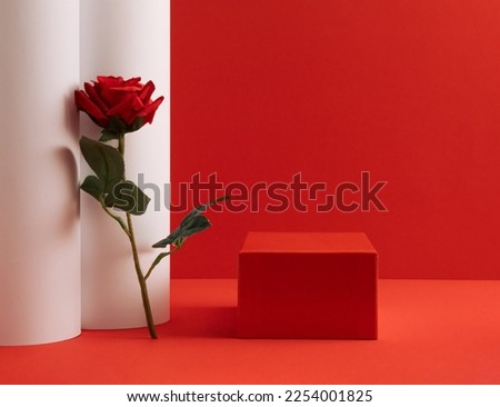 Suitable for Product Display and Business Concept. Modern aesthetic. Product podium and fresh rose flower on red  background. Elegant beauty concept.