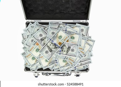 A suitcase with carelessly heap of one hundreed dollar banknotes. Isolation on white background