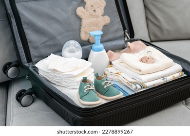 Suitcase full of baby clothes prepared for maternity hospital. Concept of getting ready for giving birth - Shutterstock ID 2278899267