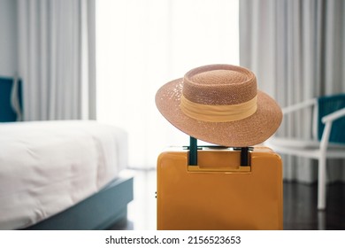 Suitcase or luggage bag with hat in a modern hotel room - relaxing time, holidays, weekend and traveling concept. copy space. - Shutterstock ID 2156523653