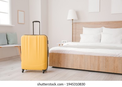 Suitcase Near Bed In Hotel Room