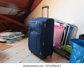 Suitcase, old things in attic. Objects of house. Cleanliness and tidiness of the house. 