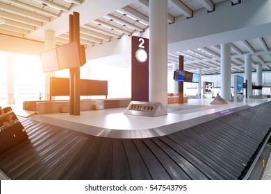 Suitcase On Luggage Conveyor Belt In The Baggage Claim At Airport