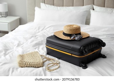 Suitcase Packed For Trip And Summer Accessories On Bed Indoors