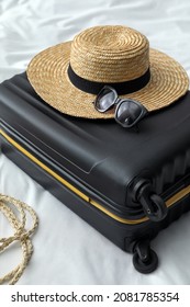 Suitcase Packed For Trip And Summer Accessories On Bed