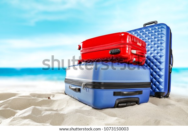 Suitcase and summer time on\
beach 