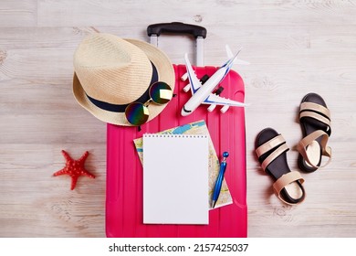 A suitcase with things and accessories for a vacation. Summer travel, preparation for the trip, packing of luggage. Travel checklist concept.