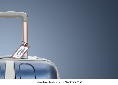 Suitcase with travel insurance label on blue background. - Powered by Shutterstock