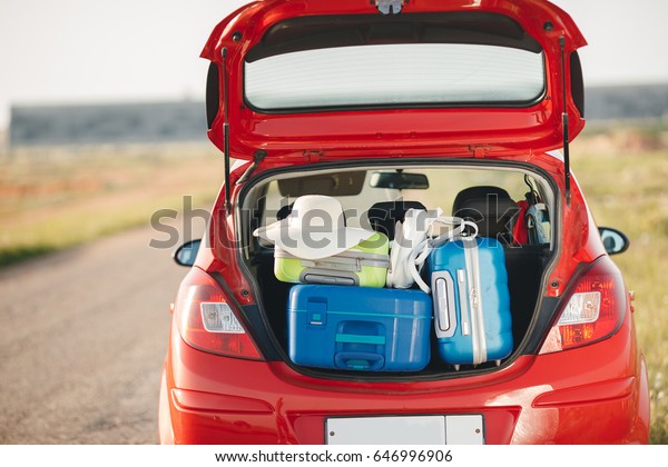 Suitcases and bags in
trunk of car ready to depart for holidays. Moving boxes and
suitcases in trunk of car, outdoors. trip, travel, sea. car on the
beach with sea on
background