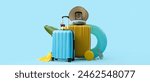 Suitcases with beach accessories on blue background with space for text