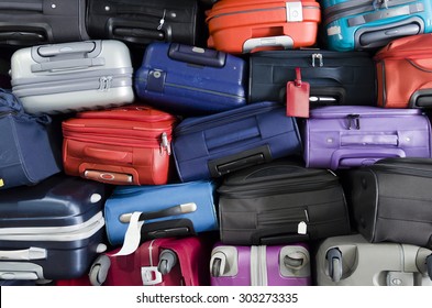 Suitcases multicolor stacked for transport one above the other - Shutterstock ID 303273335