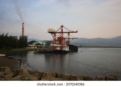 Sukabumi, West Java, Indonesia - August 23, 2021: Landscape View Of A Coal Power Plant With Industrial Smoke Pollution And Water Break Foreground At Pelabuhan Ratu Sukabumi, West Java, Indonesia